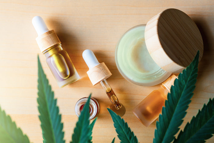 CBD oil and cream with hemp leaves