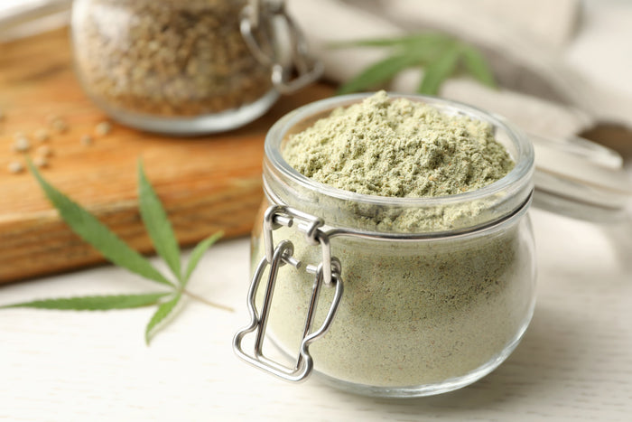 Glass jar of green hemp powder